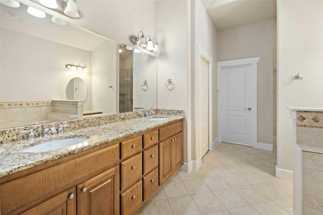 bathroom featuring vanity, a shower, and tile patterned floors