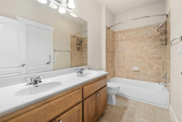 full bathroom featuring toilet, tiled shower / bath, tile patterned flooring, and vanity