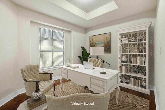 office with hardwood / wood-style flooring and a raised ceiling