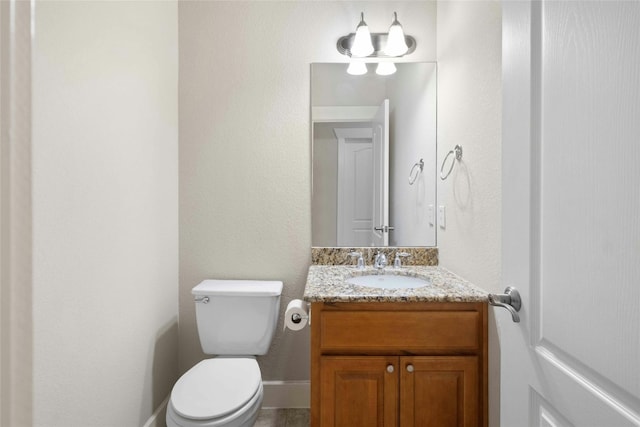 bathroom featuring toilet and vanity