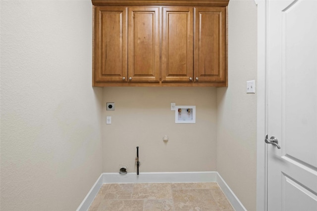 laundry area with electric dryer hookup, hookup for a washing machine, hookup for a gas dryer, and cabinets