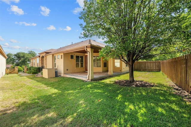 back of property featuring a patio area and a lawn