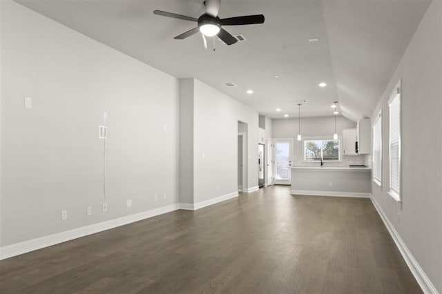 unfurnished living room featuring ceiling fan, dark hardwood / wood-style flooring, and lofted ceiling