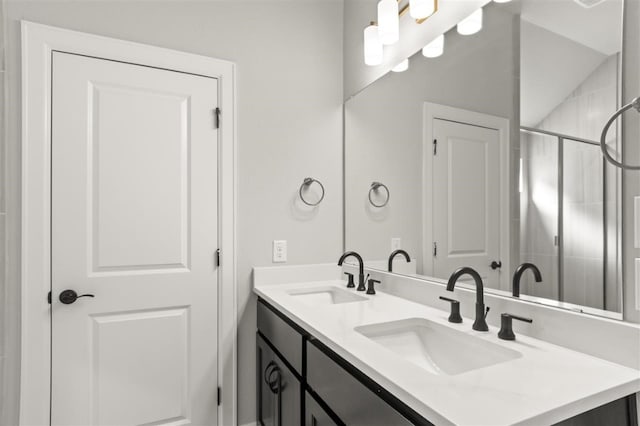 bathroom with vanity and a shower with door