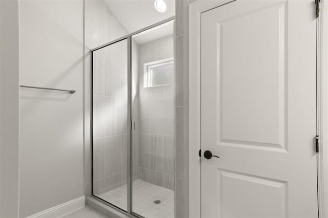 bathroom featuring a shower with door and vaulted ceiling