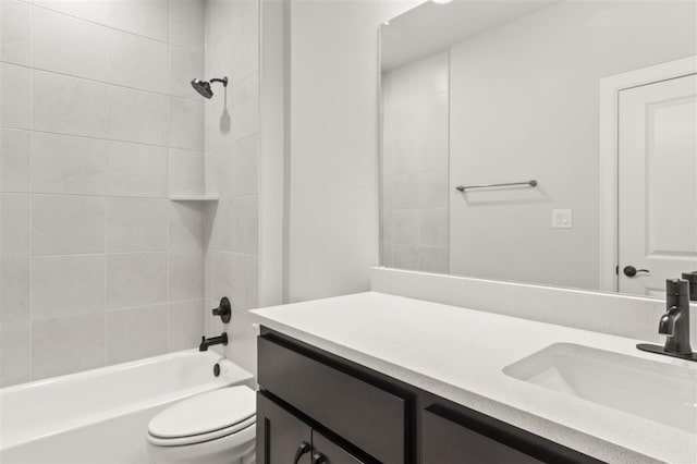 full bathroom featuring toilet, vanity, and tiled shower / bath