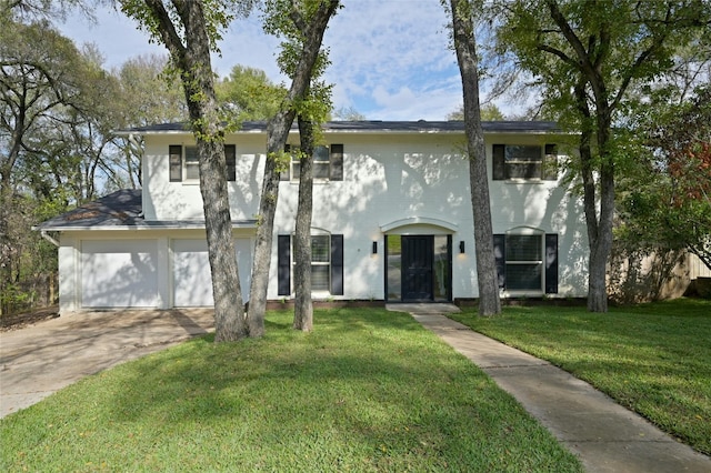 view of front of home with a front lawn and a garage