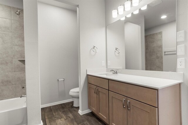 224 Barley Ln, Elgin, TX 78621 - full bath with vanity, toilet, baseboards, washtub / shower combination, and wood finished floors