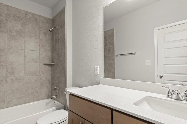 224 Barley Ln, Elgin, TX 78621 - bathroom featuring toilet, vanity, a textured wall, and washtub / shower combination
