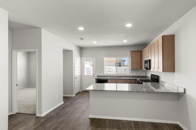 224 Barley Ln, Elgin, TX 78621 - kitchen with a sink, a peninsula, black dishwasher, visible vents, and range with gas cooktop