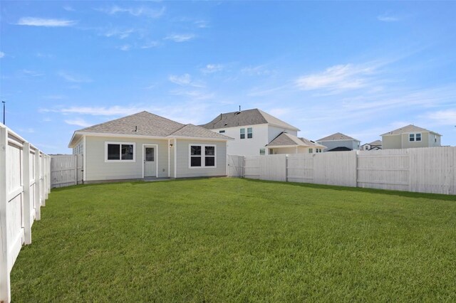 224 Barley Ln, Elgin, TX 78621 - back of house with a fenced backyard and a lawn