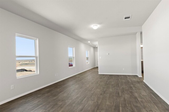 224 Barley Ln, Elgin, TX 78621 - unfurnished room with baseboards, visible vents, and dark wood-style flooring