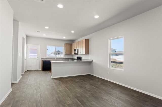 224 Barley Ln, Elgin, TX 78621 - kitchen featuring dark wood-style flooring, stove, and baseboards