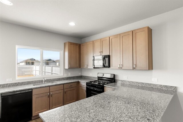 224 Barley Ln, Elgin, TX 78621 - kitchen featuring a sink, black appliances, recessed lighting, and a peninsula