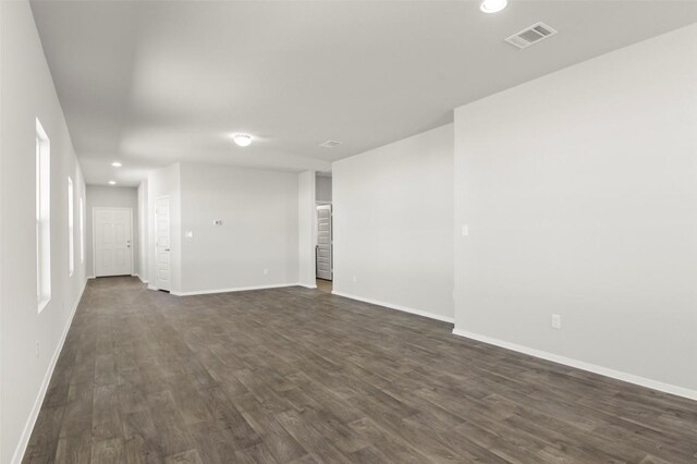 224 Barley Ln, Elgin, TX 78621 - spare room featuring dark wood-style flooring, recessed lighting, baseboards, and visible vents