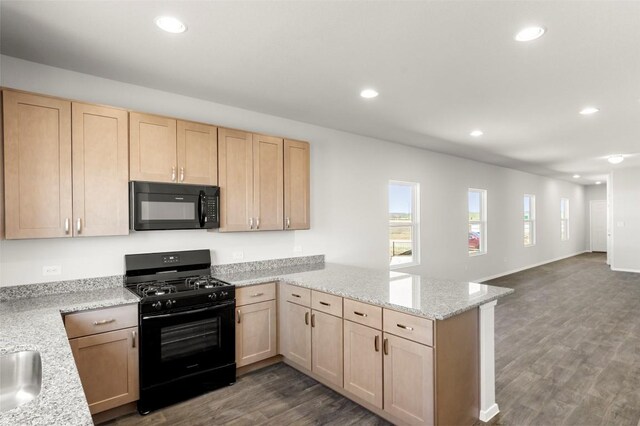 224 Barley Ln, Elgin, TX 78621 - kitchen featuring a peninsula, black appliances, and light brown cabinetry