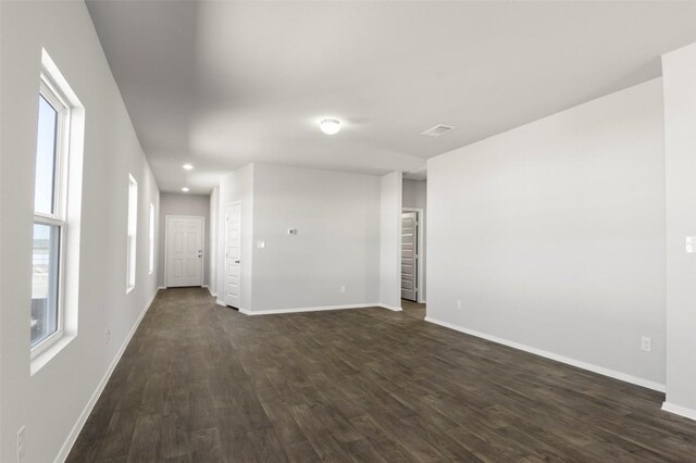 224 Barley Ln, Elgin, TX 78621 - unfurnished living room with baseboards, dark wood-style flooring, recessed lighting, and a healthy amount of sunlight
