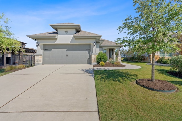 view of front of home with a front yard and a garage