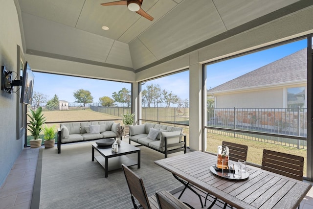 sunroom / solarium with ceiling fan and vaulted ceiling