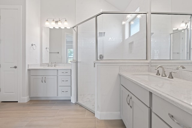 bathroom featuring vanity and a shower with door