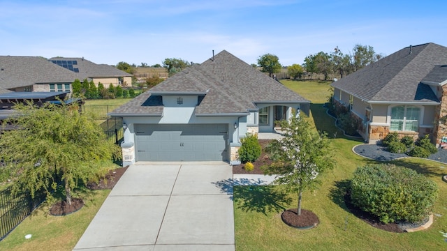 view of front of house with a front yard and a garage