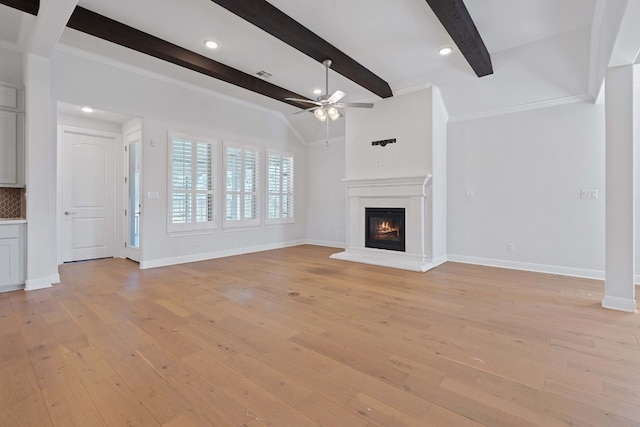 unfurnished living room with beamed ceiling, ceiling fan, light wood-type flooring, and crown molding