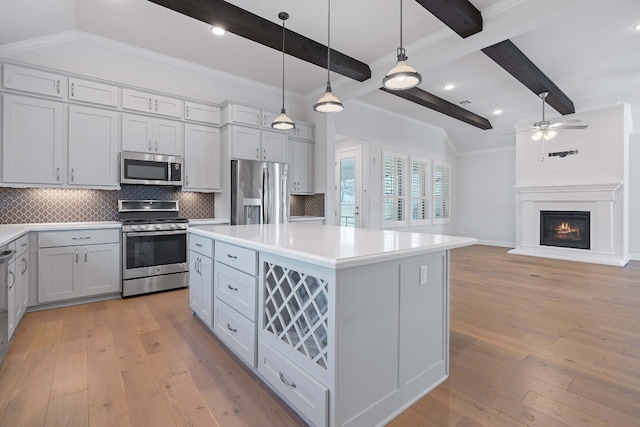 kitchen with tasteful backsplash, stainless steel appliances, light hardwood / wood-style flooring, beamed ceiling, and a kitchen island