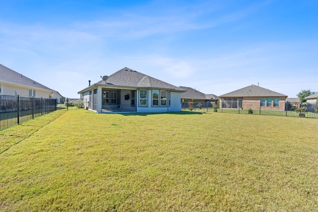 back of house with a lawn