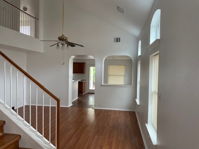 interior space with ceiling fan, dark hardwood / wood-style flooring, and high vaulted ceiling