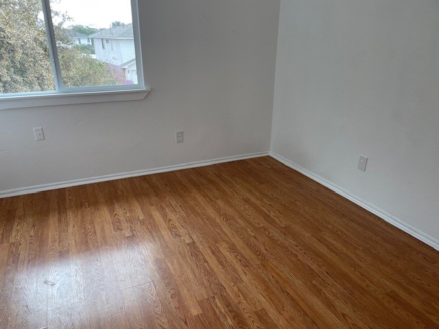 empty room featuring hardwood / wood-style flooring