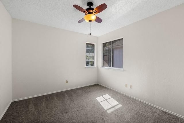 carpeted spare room with ceiling fan and a textured ceiling