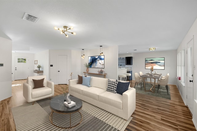 living room featuring hardwood / wood-style floors and an inviting chandelier