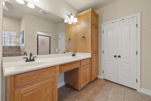 bathroom with tile patterned floors and vanity