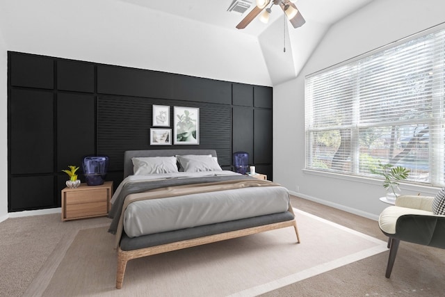 bedroom with ceiling fan, lofted ceiling, and light carpet