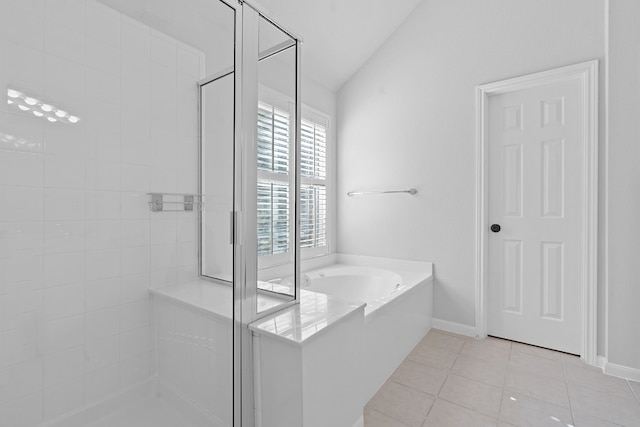 bathroom with tile patterned flooring, vaulted ceiling, and independent shower and bath