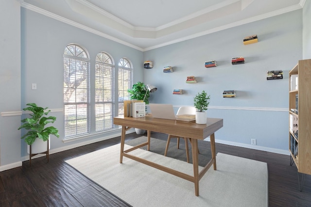 home office featuring ornamental molding, dark wood-type flooring, and a tray ceiling