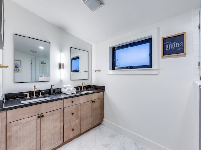 bathroom with vanity and vaulted ceiling