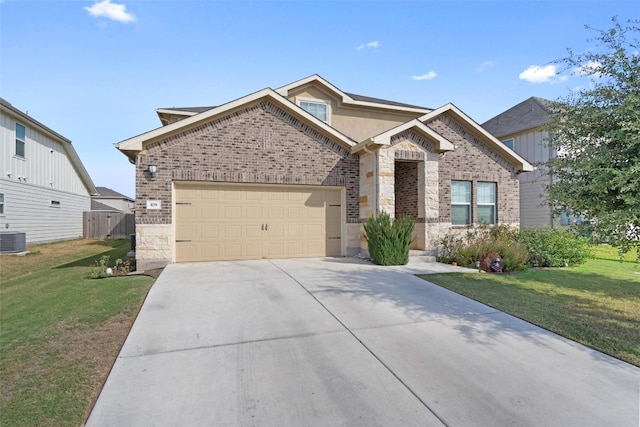 view of front of home with a garage, a front yard, and central AC