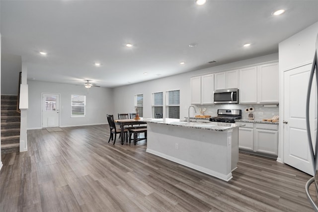 kitchen featuring white cabinets, dark wood-type flooring, and appliances with stainless steel finishes