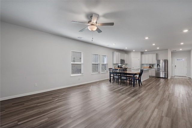 dining room with ceiling fan and light hardwood / wood-style floors