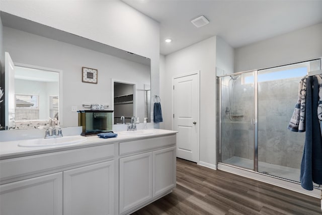 bathroom with walk in shower, wood-type flooring, vanity, and plenty of natural light