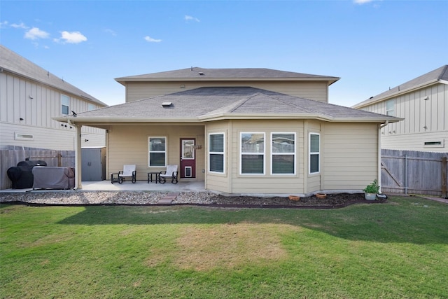 back of property featuring a lawn and a patio area