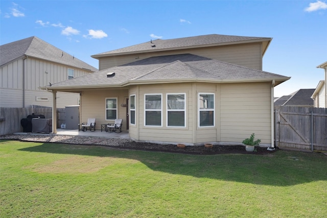 rear view of house featuring a patio area and a yard