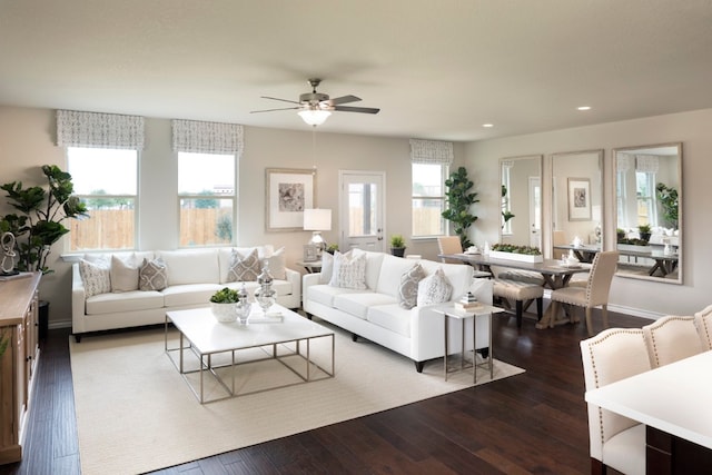 living room featuring ceiling fan and dark hardwood / wood-style flooring