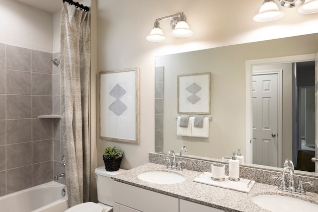 full bathroom featuring shower / bath combo, vanity, and toilet