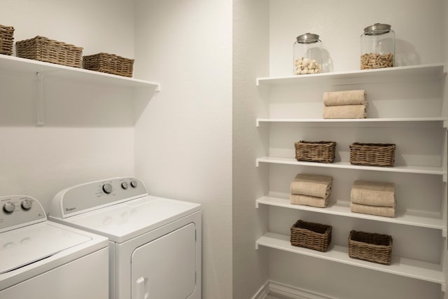 clothes washing area with washing machine and clothes dryer