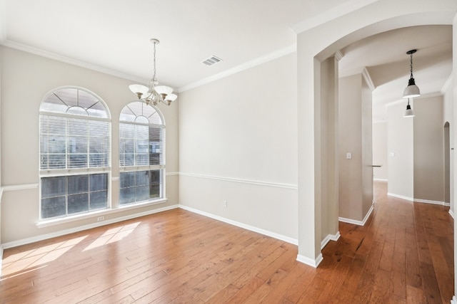 unfurnished dining area with hardwood / wood-style floors and ornamental molding