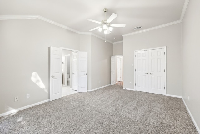 unfurnished bedroom with ceiling fan, carpet floors, crown molding, and a closet