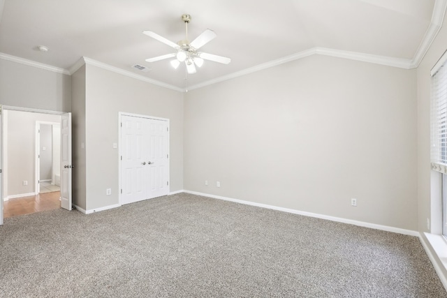 unfurnished bedroom featuring carpet flooring, a closet, ceiling fan, and crown molding