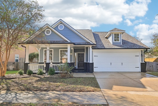 view of front of home with covered porch and a garage